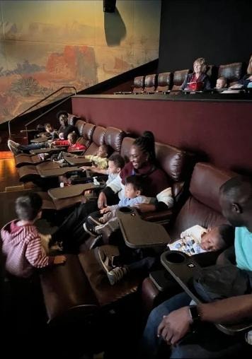 Families and children enjoying a movie outing together
