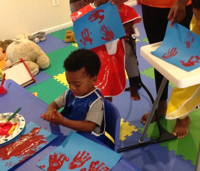 Children creating hand-painting artwork together