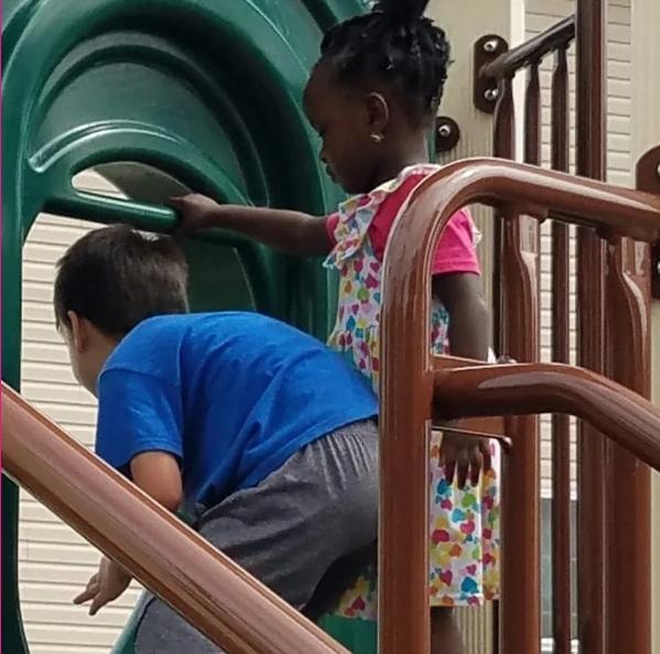 Children playing together on a playground slide